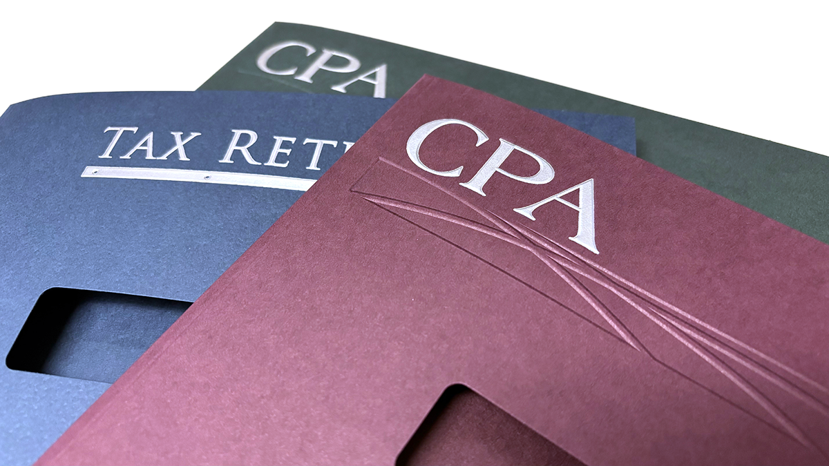 Foil-embossed CPA and tax return slip sheet folders stacked on a blue background